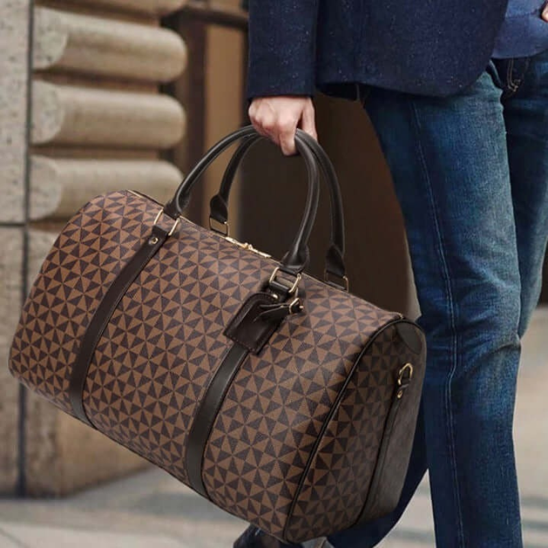 Elegant brown unisex duffle bag, a stylish and spacious carry-on for travel and weekend trips.