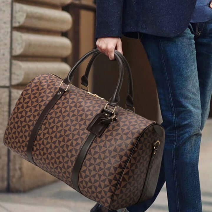 Elegant brown unisex duffle bag, a stylish and spacious carry-on for travel and weekend trips.