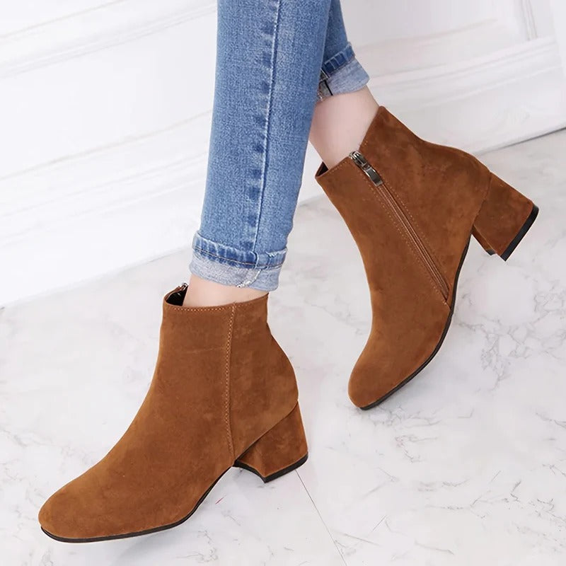 Stylish women's black ankle boots with a comfortable block heel & convenient side zip, perfect for fall fashion.