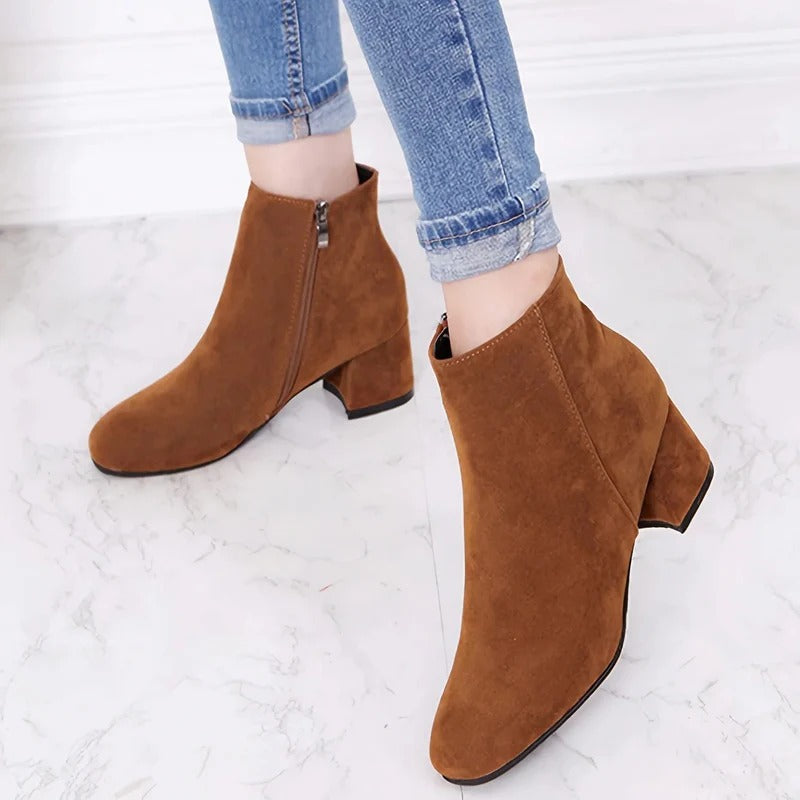 Women's versatile ankle boots featuring a sturdy block heel and practical side zip for effortless everyday style.