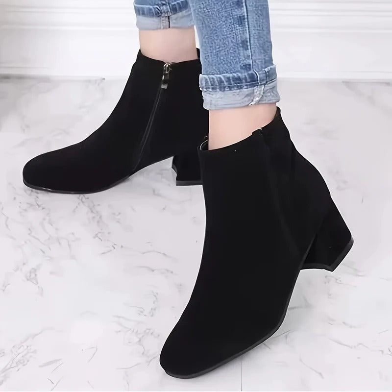 Comfortable women's heeled ankle boots with a chic block heel & side zip closure, ideal for casual winter wear.