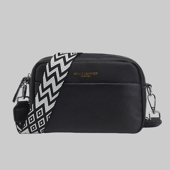 Stylish women's crossbody bag with unique geometric strap. Versatile fashion accessory for everyday use.
