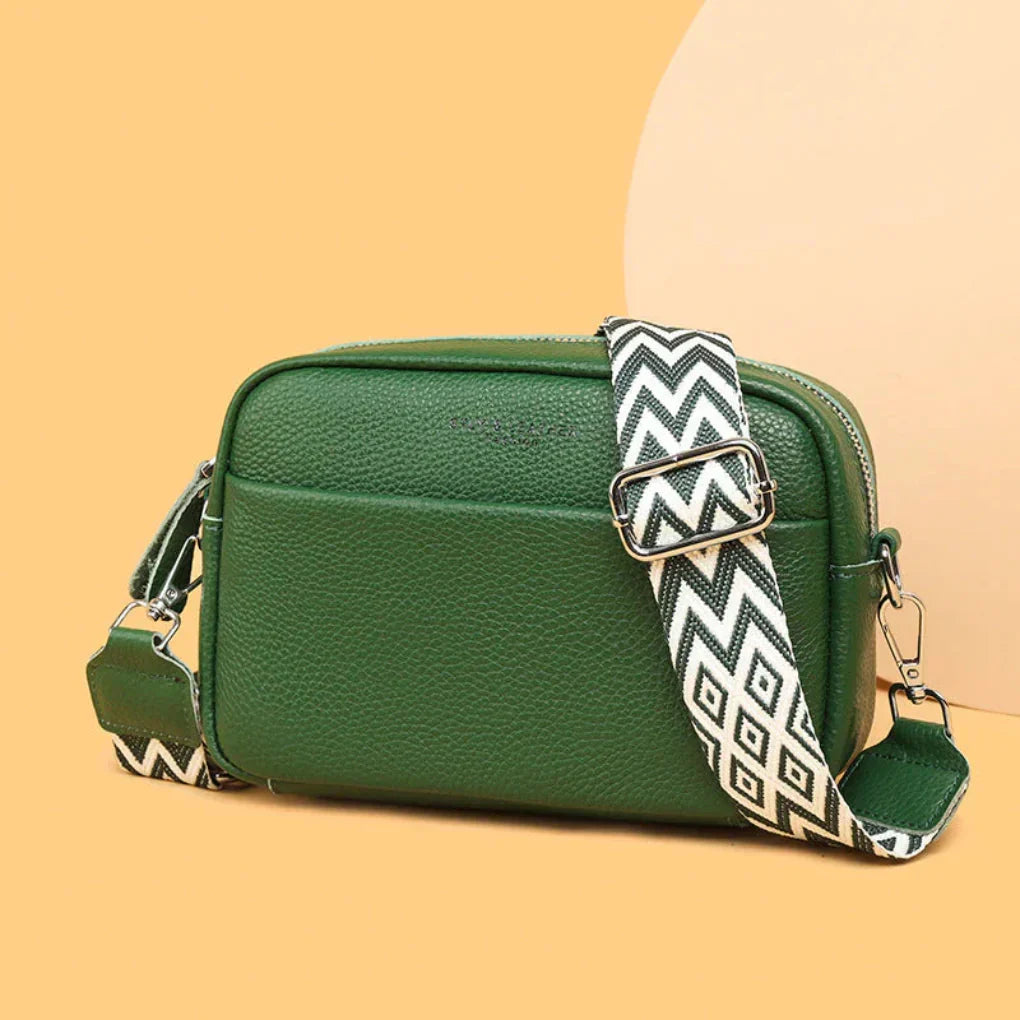 Fashionable blue women's crossbody bag. This versatile handbag features a distinctive geometric strap.