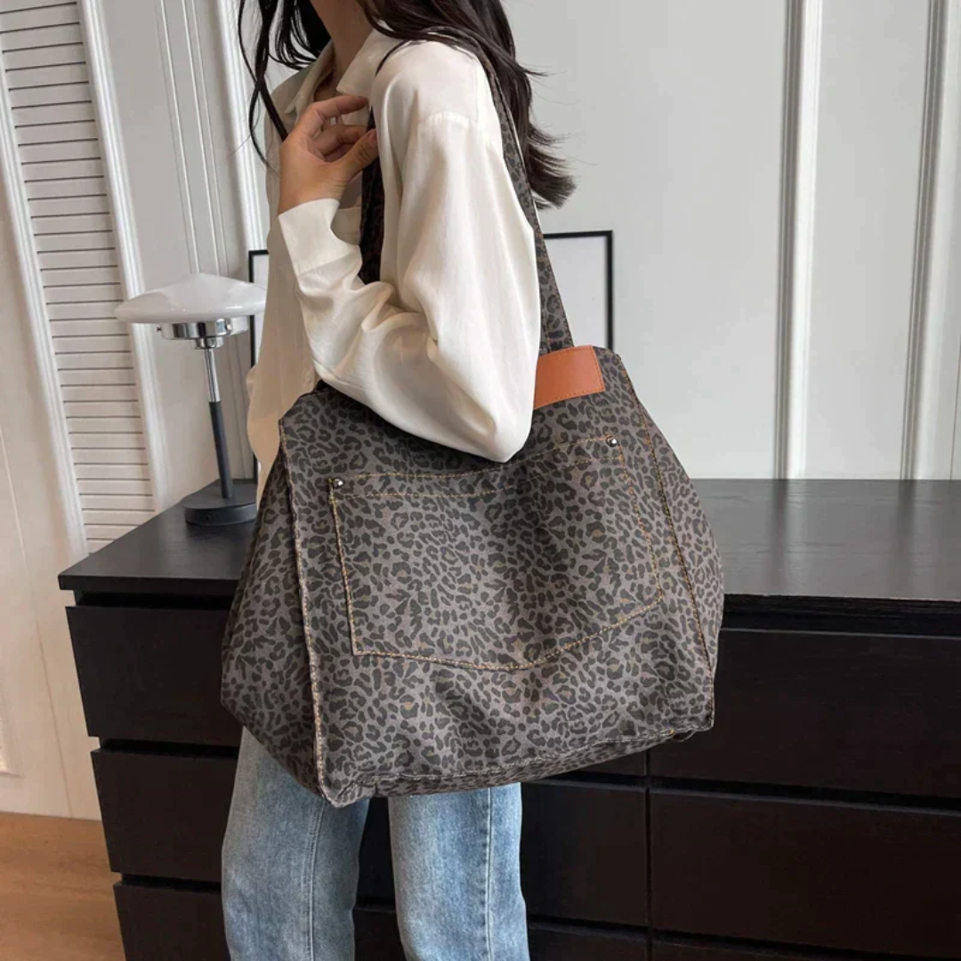 Back view of women's leopard print handbag, showcasing the sleek design and quality faux leather finish.