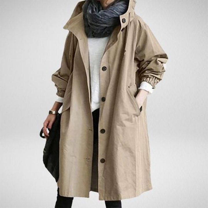 Modern women's long waterproof raincoat, designed for stylish and effective protection against rain.
