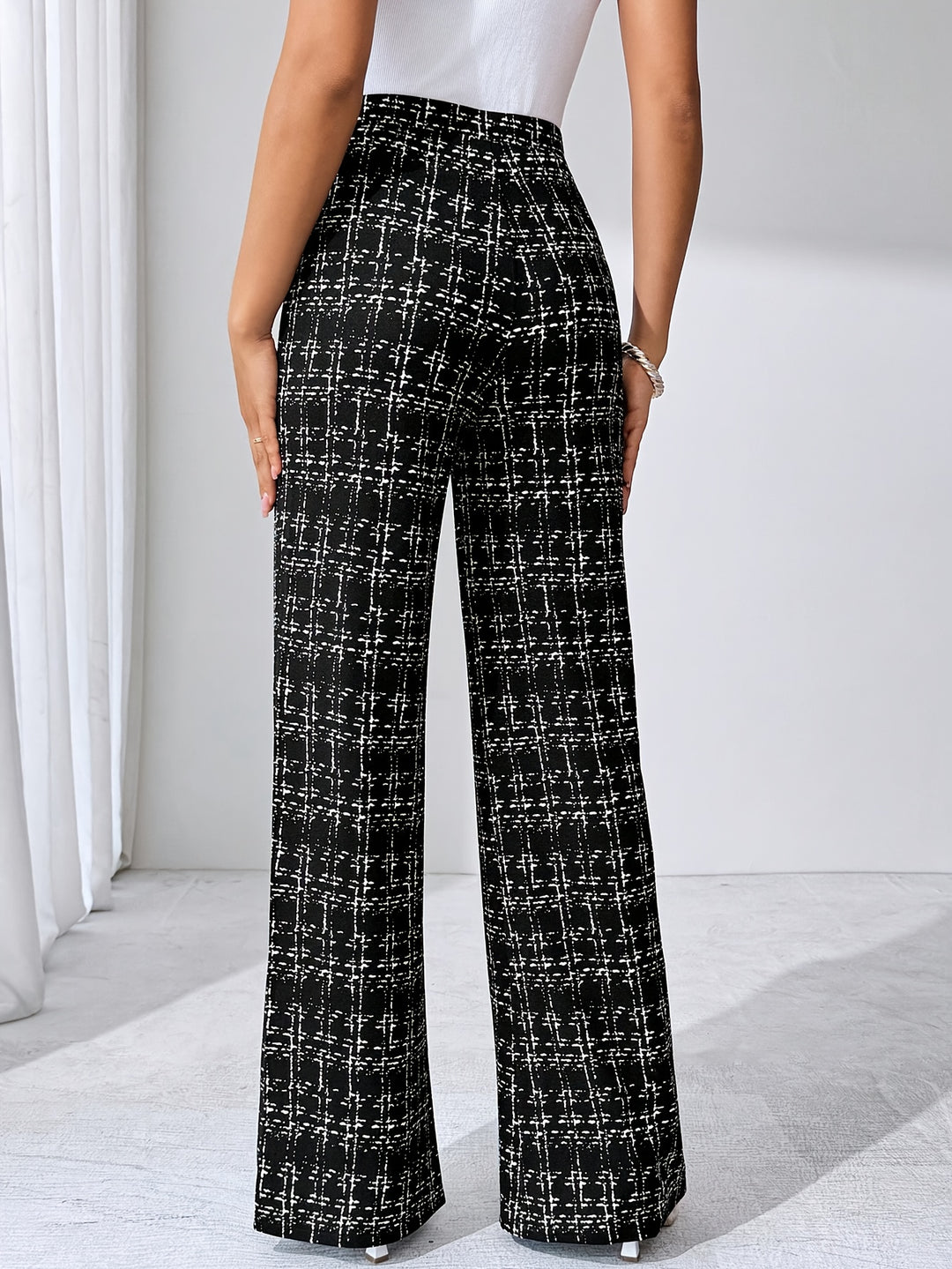 Full shot of women's comfortable knit plaid flare pants, flattering high waist design.