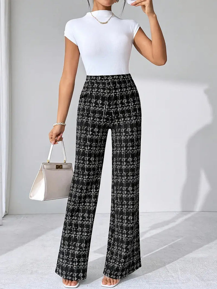 Model wearing women's high-waisted plaid knit pants, showcasing the flared silhouette.