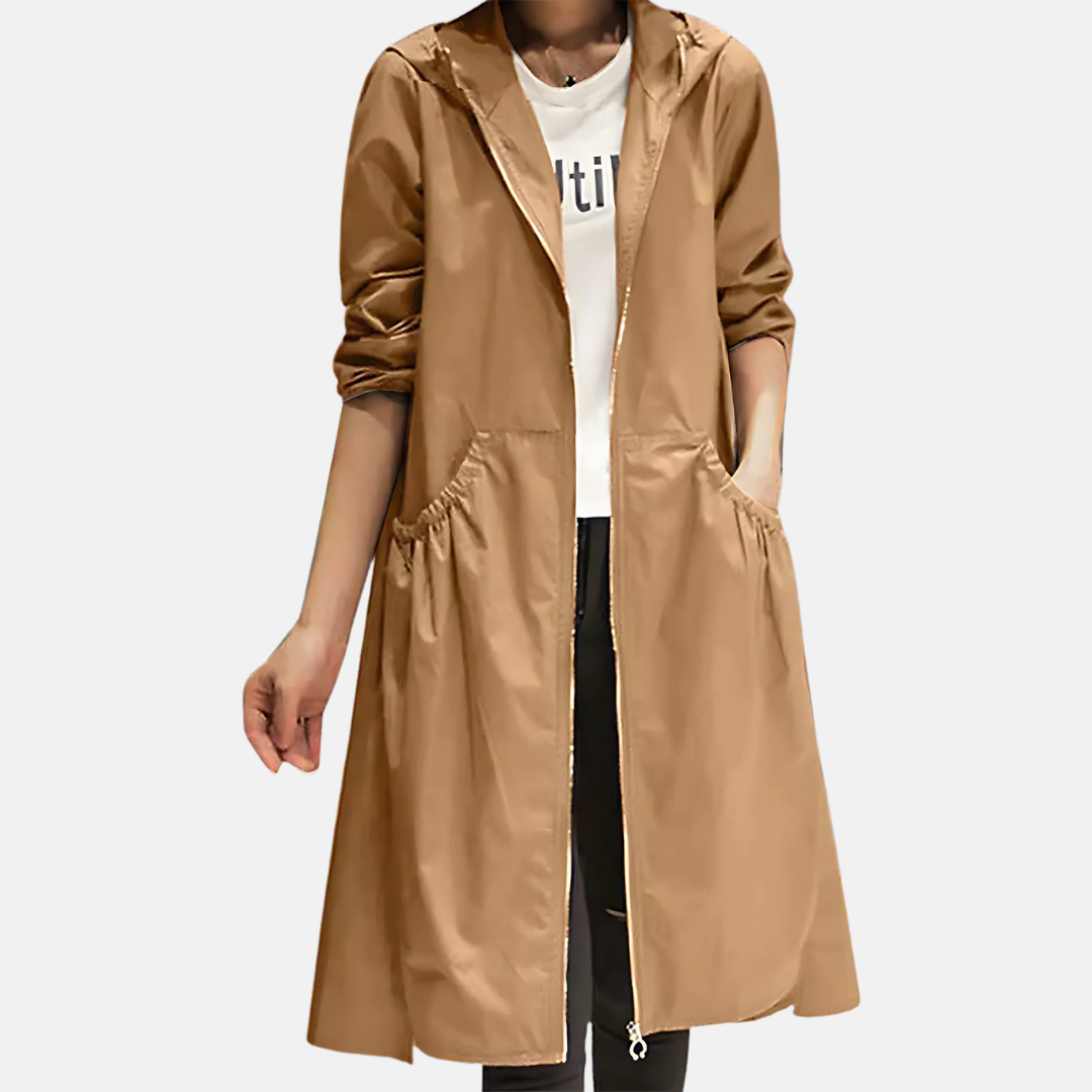 Woman wearing a lightweight, knee-length hooded rain jacket, ideal water-resistant outerwear for casual spring days.