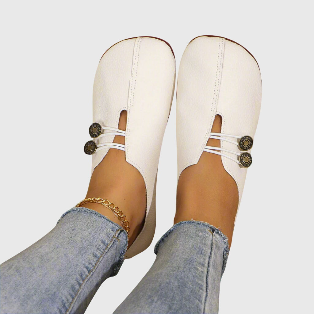 Chic women's summer flats featuring a decorative button. Easy-wear slip-on design for ultimate comfort.