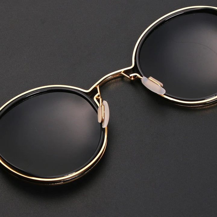 Fashion accessory: Unisex polarized round sunglasses with gold metal temples, offering stylish UV protection.