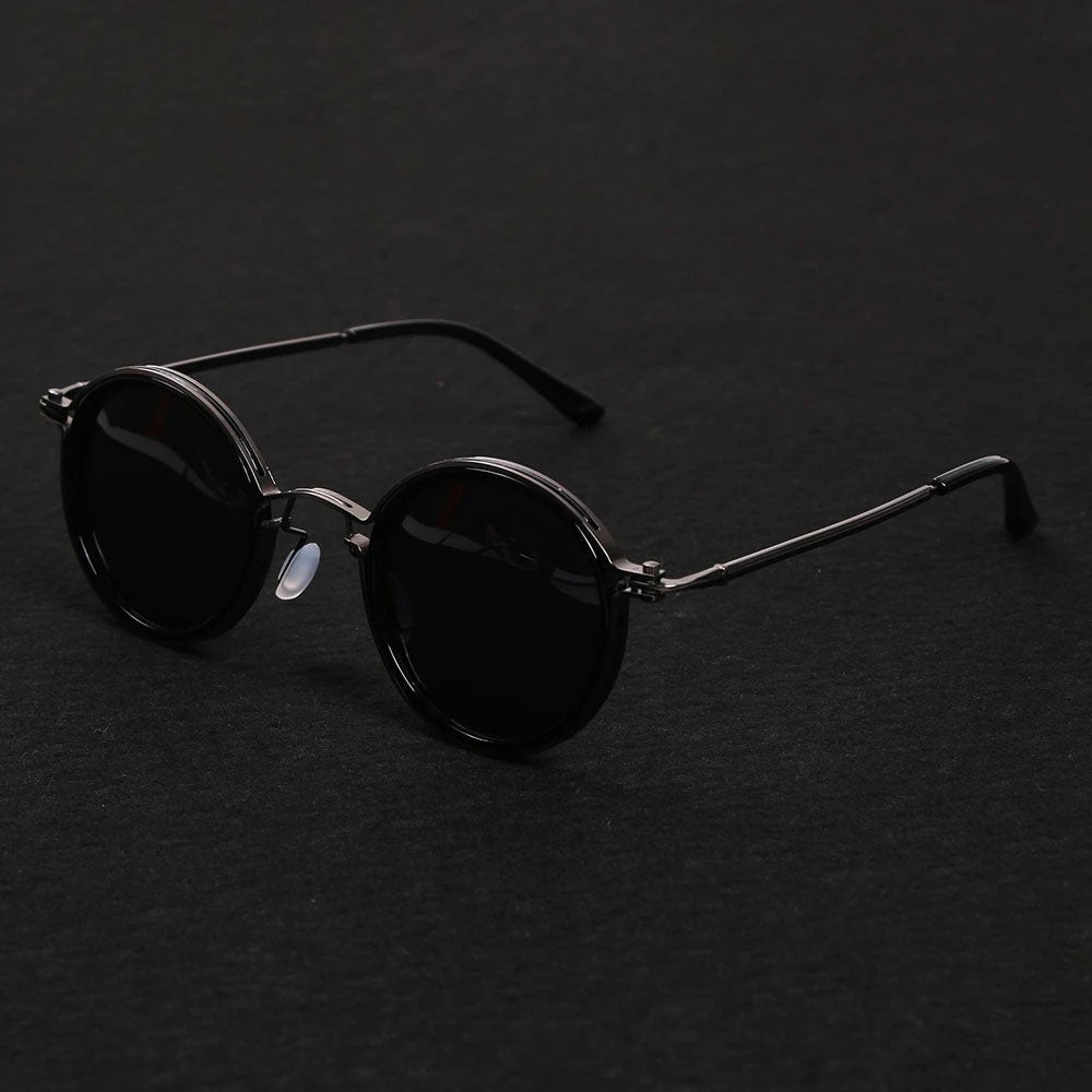 Close-up of gold metal temples on sleek unisex polarized round sunglasses, emphasizing quality.