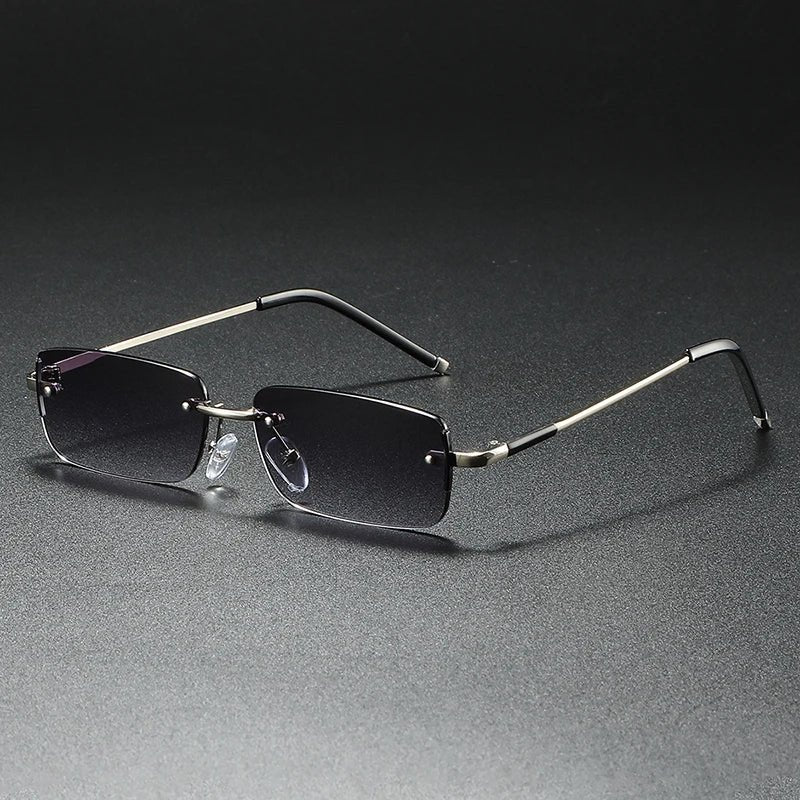 Sleek gold rimless rectangular sunglasses for men & women. Features fashion-forward gradient lenses & UV protection.