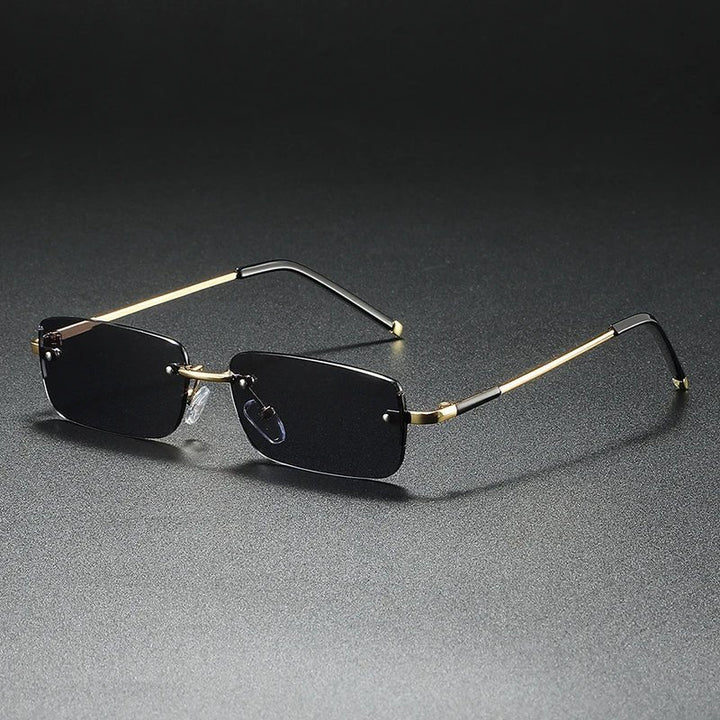Modern unisex rimless gold rectangular sunglasses with gradient lenses. Offers UV protection & a lightweight design.