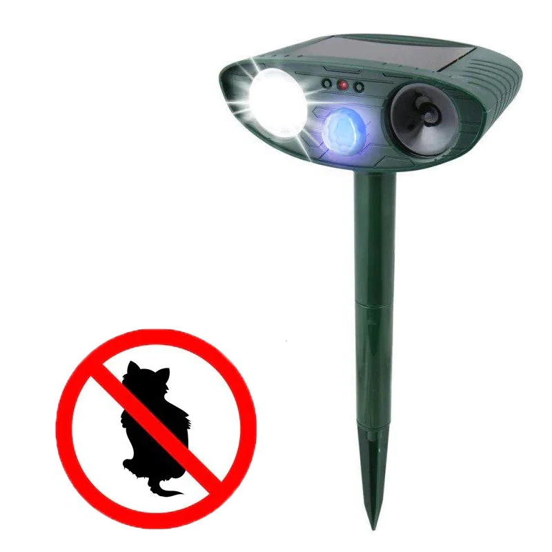Solar powered ultrasonic dog repeller in a garden, motion-activated for humane pest control and yard protection.