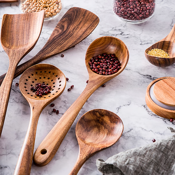 "Teak wood kitchen utensils set, eco-friendly and non-toxic, showcasing natural grain, perfect for sustainable cooking."