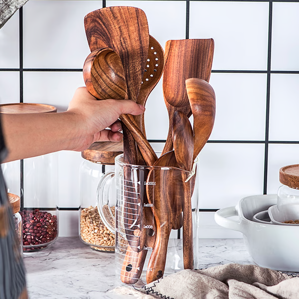 "Teak wood kitchen utensils set, eco-friendly and non-toxic, showcasing natural grain, perfect for sustainable cooking."