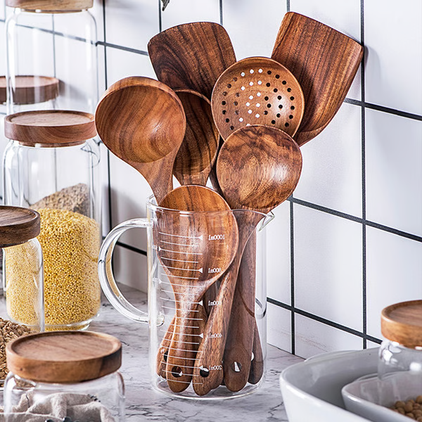 "Teak wood kitchen utensils set, eco-friendly and non-toxic, showcasing natural grain, perfect for sustainable cooking."