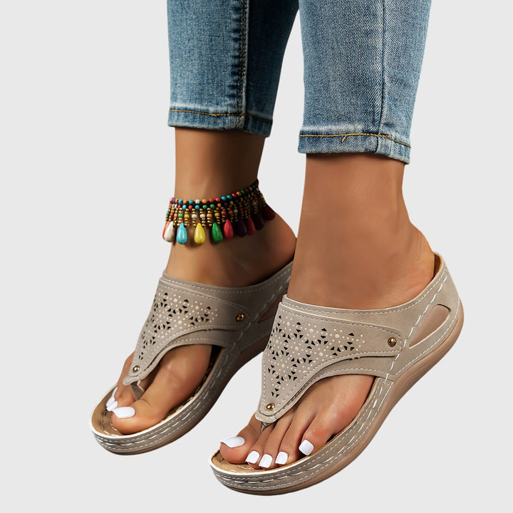 Stylish Theodoros women's platform sandals featuring an open toe, secure ankle strap & perforated design.