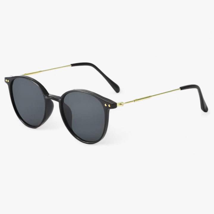 Timeless luxury women's round frame sunglasses with UV protection. Stylish retro black eyewear for summer fashion.