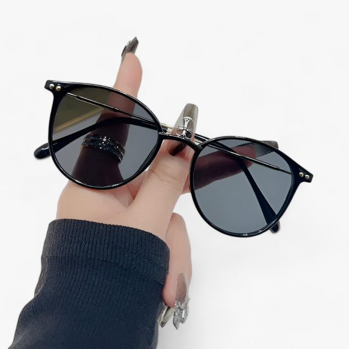 Elegant women's round frame sunglasses with UV protection. Retro luxury eyewear, a stylish summer essential fashion accessory.