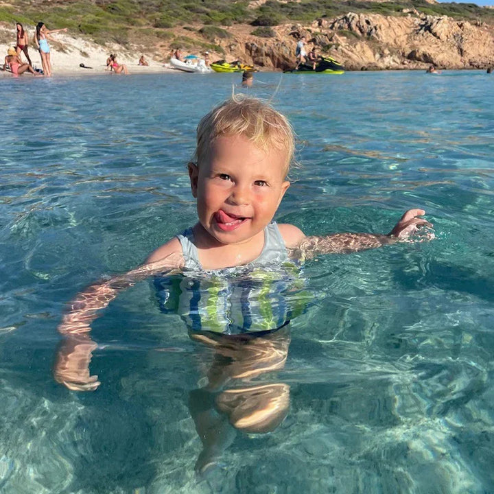 Safe toddler swim vest with UV 50+ sun protection, perfect for beach adventures.