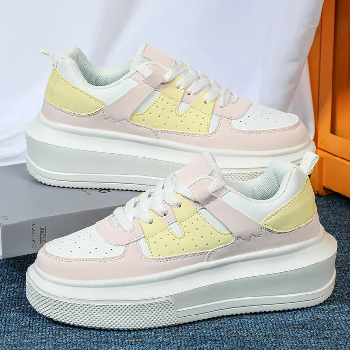 White women's platform sneakers, perforated lace-up design for a trendy, comfortable casual look.