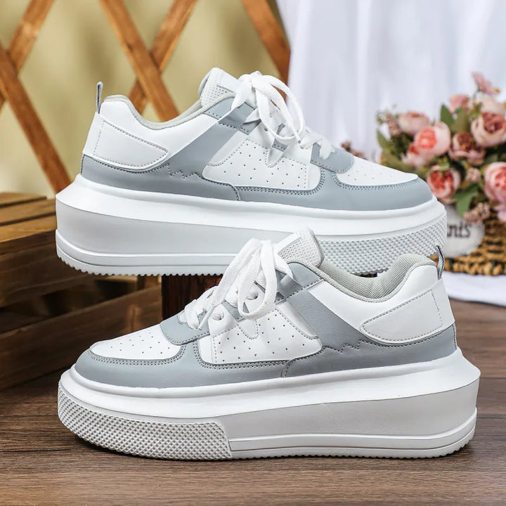 Stylish women's platform sneakers, high sole, perforated upper, and lace-up for trendy casual comfort.
