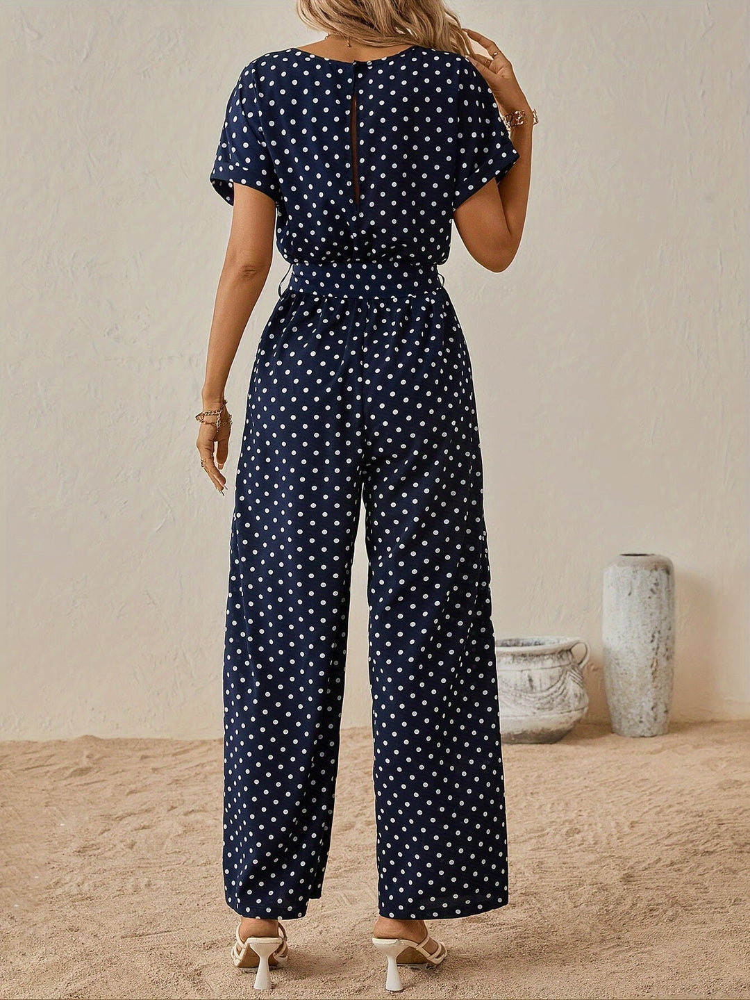 Stylish women's short sleeve polka dot jumpsuit, a trendy one-piece for casual summer outings.