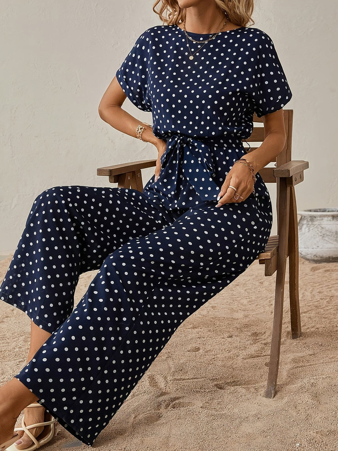 Modern women's polka dot jumpsuit featuring an elastic waistband, versatile for spring & summer style.