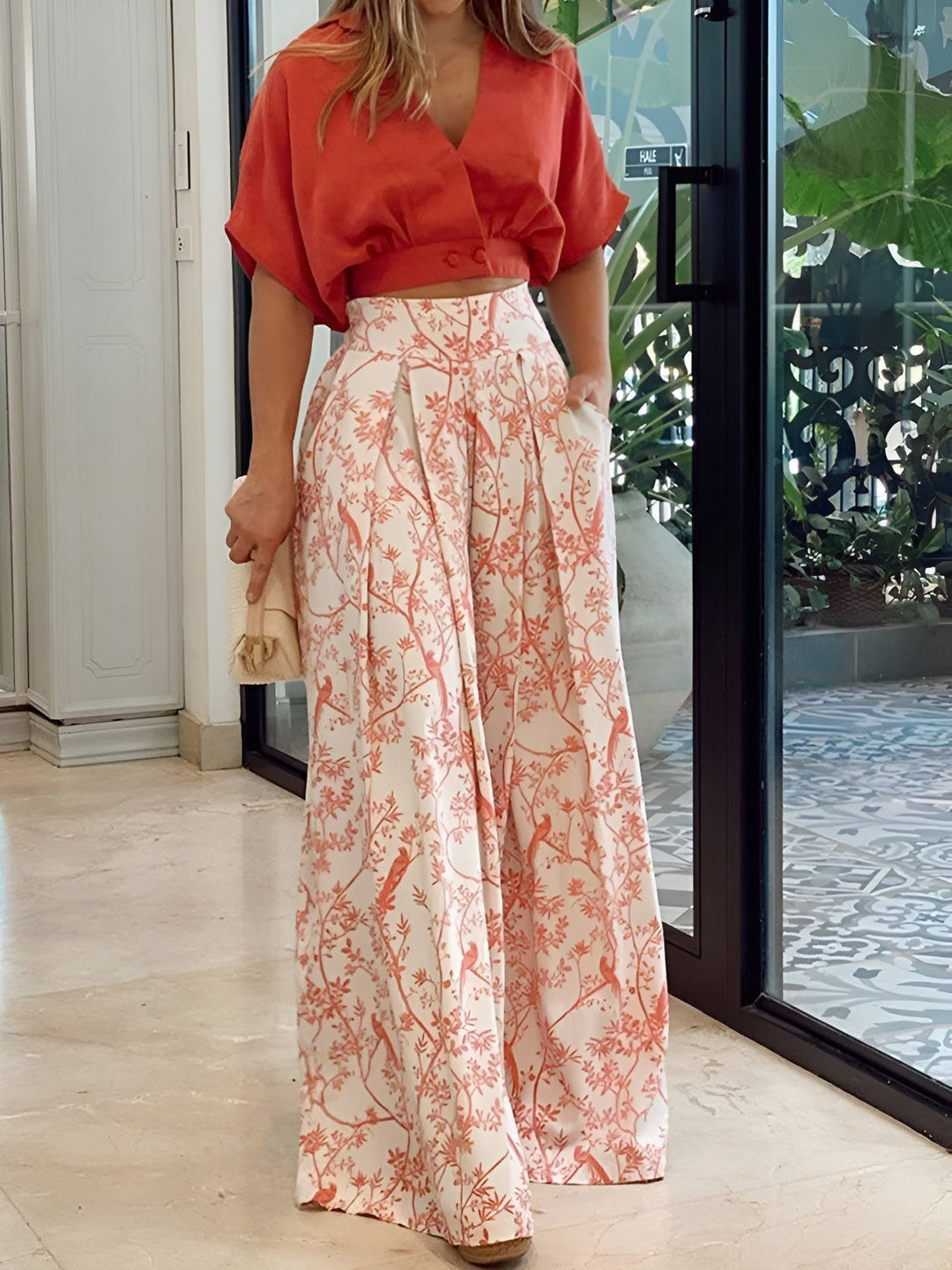 Stylish women's summer outfit: comfortable two-piece set featuring a chic blouse & wide-leg pants for versatile fashion.