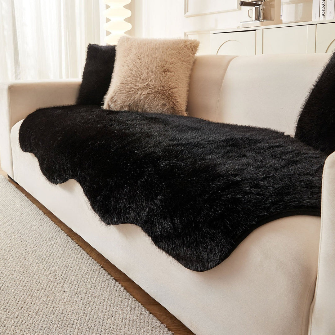 Black ultra-soft sofa cover for living room. Modern Scandinavian style couch protector and fluffy blanket.