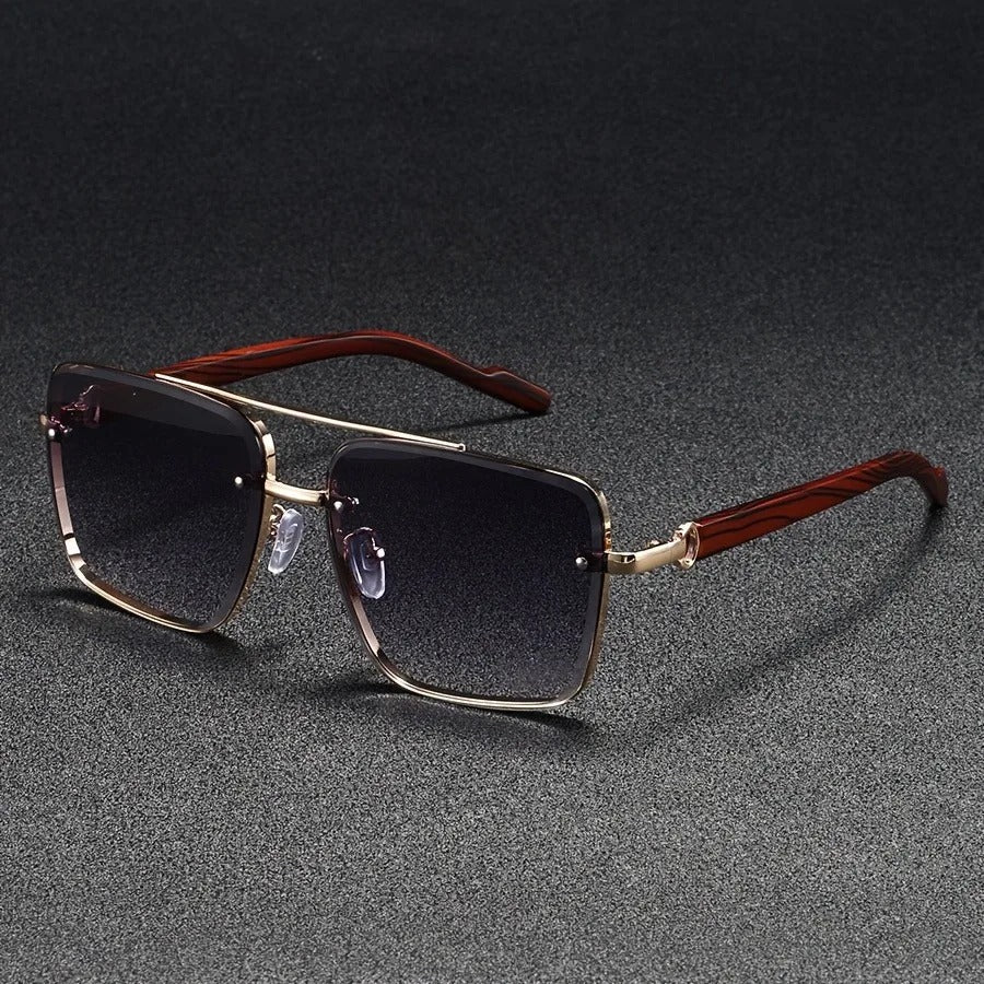 Close-up of the lens and frame of bold square unisex sunglasses in gold and wood, vintage style.