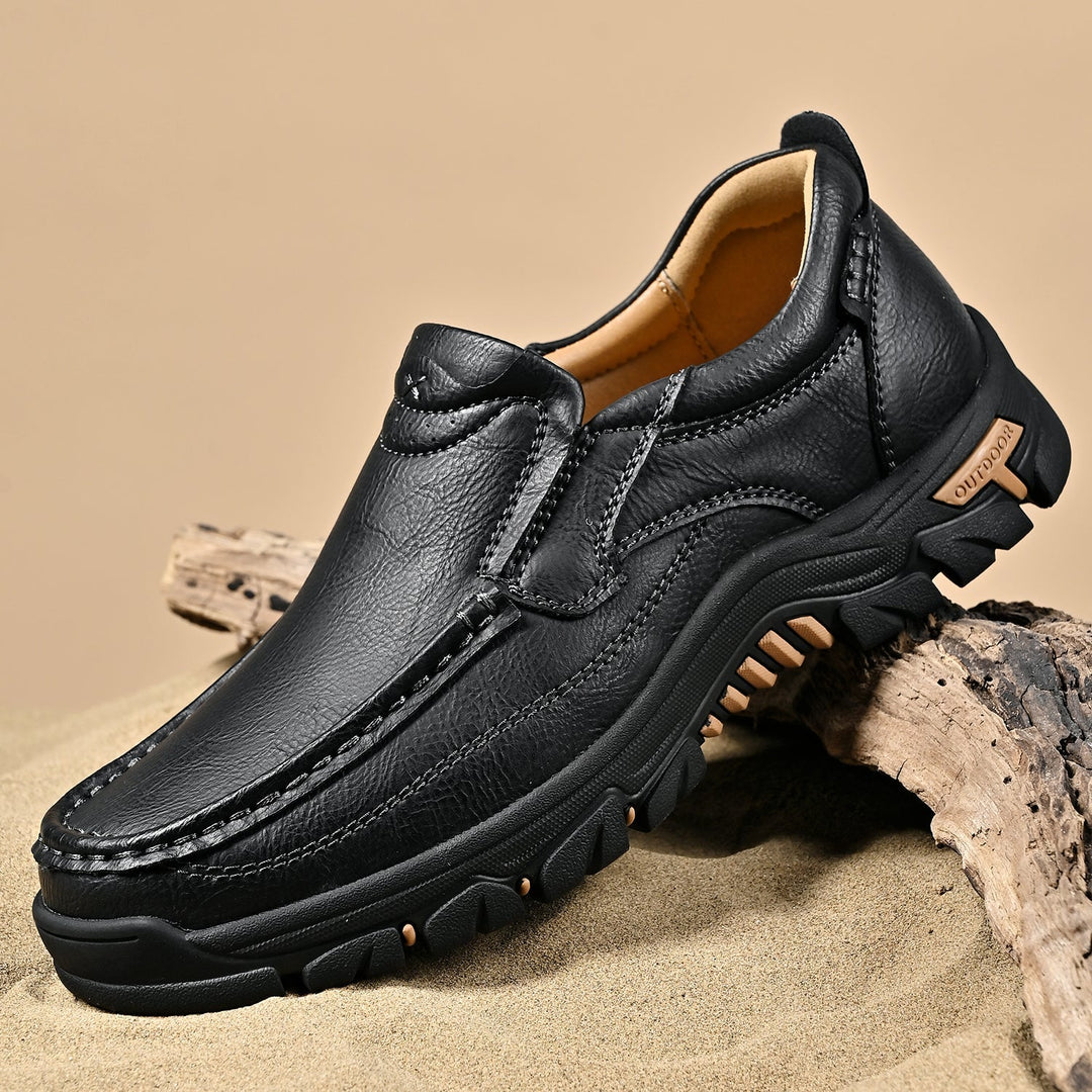 Lifestyle image of brown orthopedic comfort boots being worn by a man, casual setting