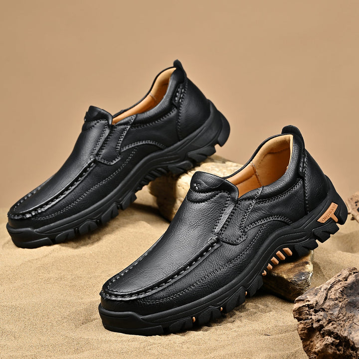 Pair of brown leather orthopedic comfort boots on a rustic background, outdoor readiness