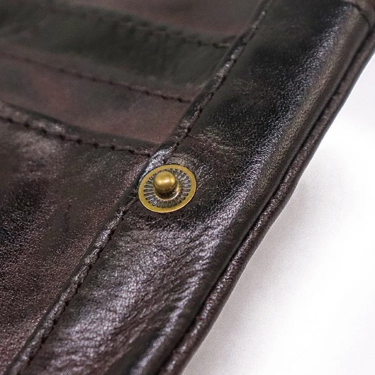 Professional shot of a distressed leather bifold wallet, snap closure visible