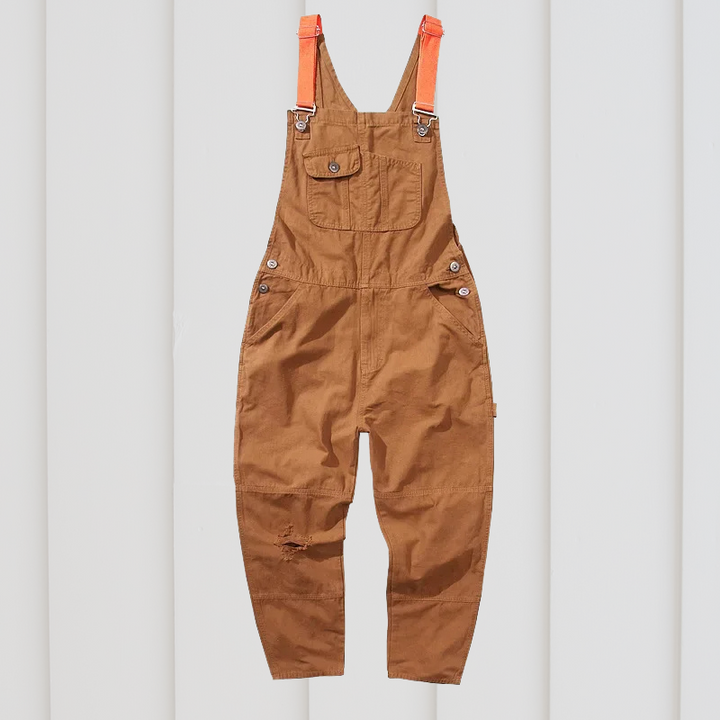 Blue/brown unisex durable cotton garden overalls. Comfortable utility workwear with ample pockets for outdoor tasks.