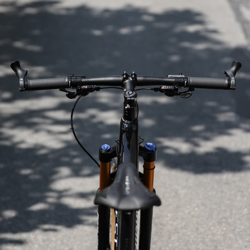 Close-up of anti-slip ergonomic handlebar grips, essential bike parts for improved control & comfort.