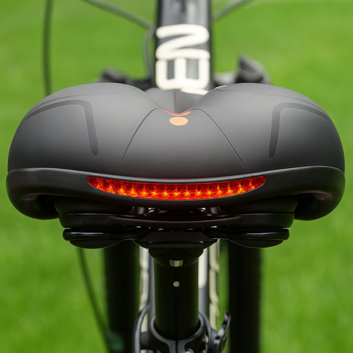 Unisex suspension bicycle seat, ergonomic design for comfortable cycling, suitable for various bike types.