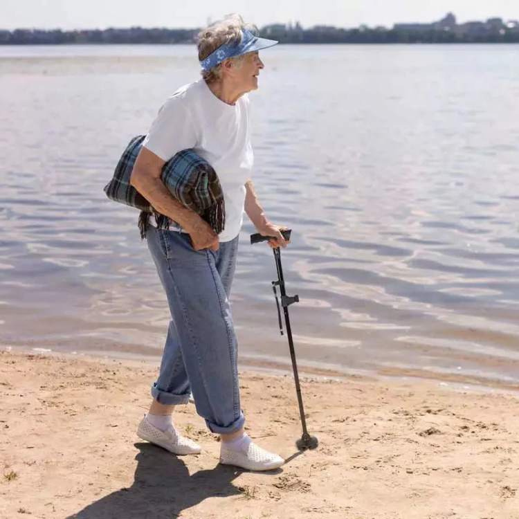 Unisex folding walking cane with built-in LED light and safety alarm, offering mobility support for elderly daily living.