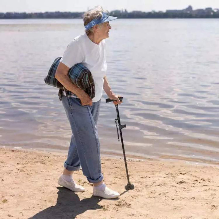 Unisex folding walking cane with built-in LED light and safety alarm, offering mobility support for elderly daily living.