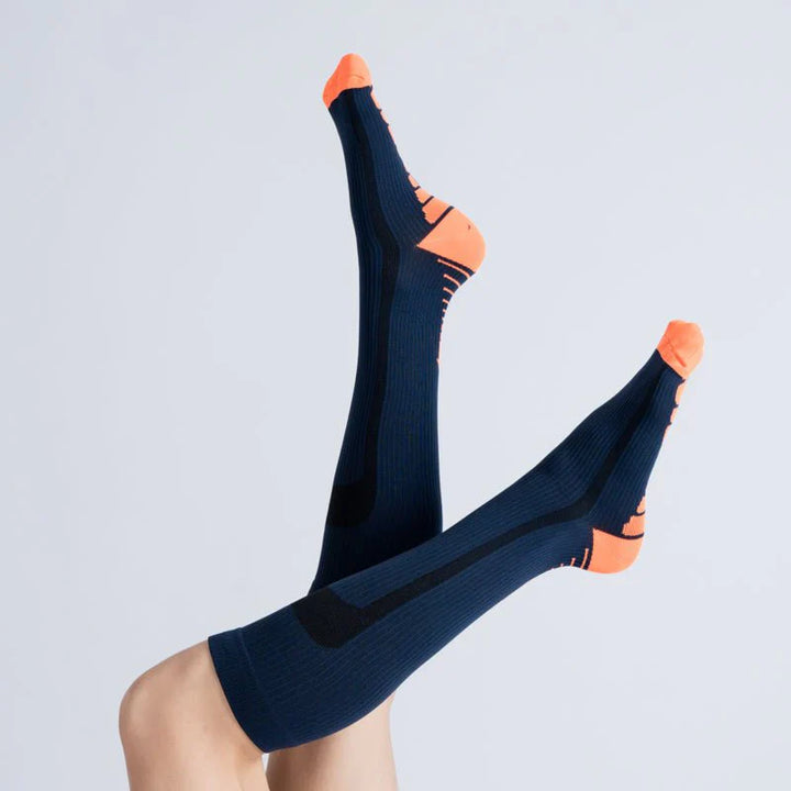 Folded blue and orange unisex compression socks, highlighting gentle support for leg comfort and daily wear