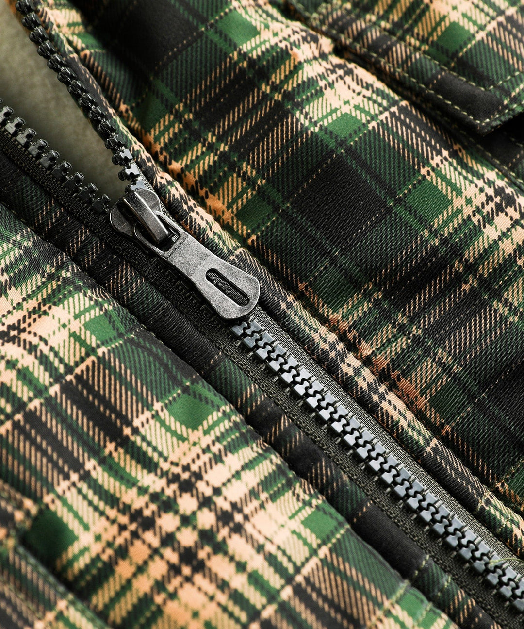 Close-up of the collar on a green insulated outdoor vest, unisex style