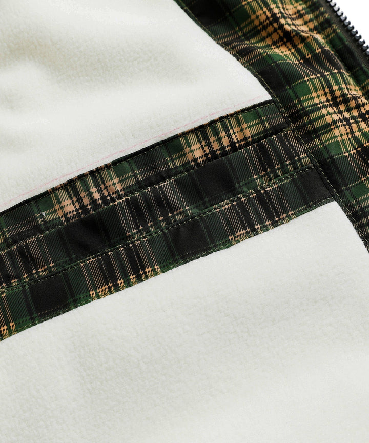 Unisex insulated vest in green, folded neatly on a camping background