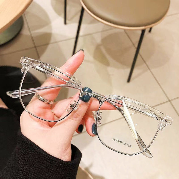 Pair of blue light blocking half-rim glasses on a desk, ready for office and gaming.