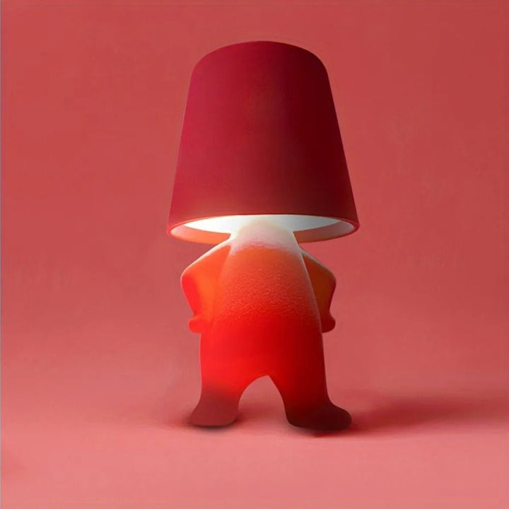 Rechargeable human figure LED light, portable and modern for creative desk lighting & mood ambiance.