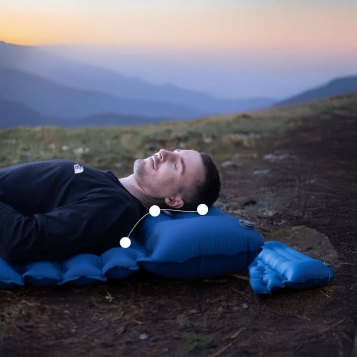 Portable inflatable mattress for camping, features integrated foot pump for quick setup.