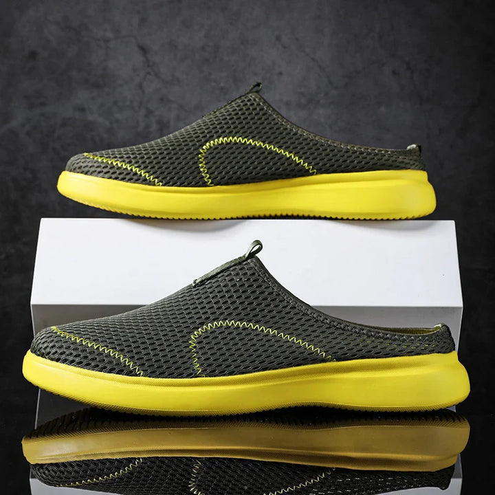 Black slip-on shoes for men and women, featuring lightweight design for everyday comfort.