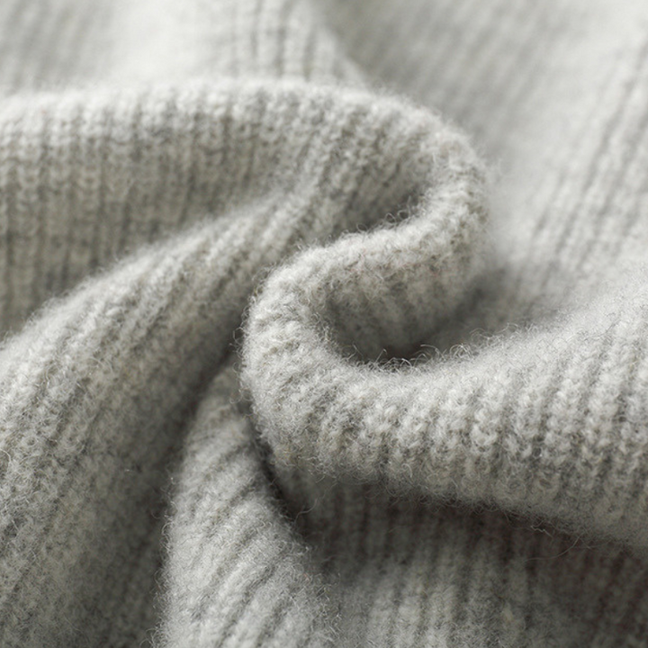 Detail of the full-zip closure on a Unisex Merino Wool Hoodie, highlighting quality knitwear.