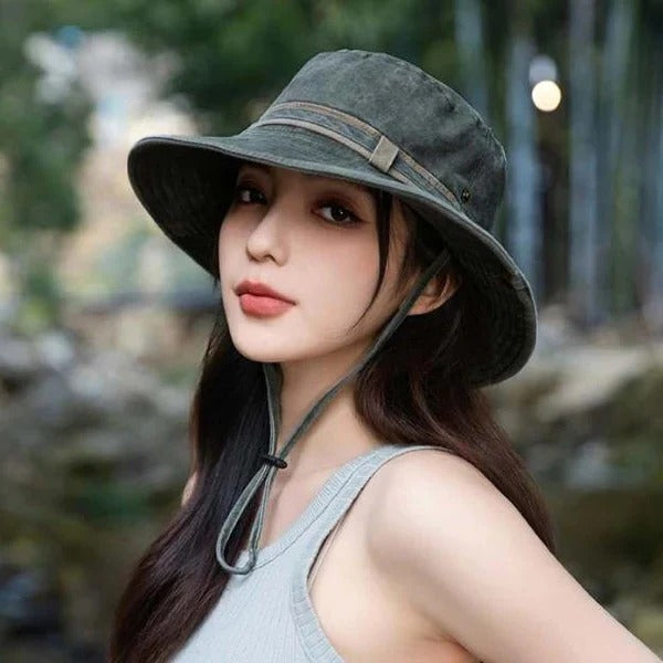 Vented unisex hiking bucket hat with adjustable chin strap for comfortable sun protection on trails.