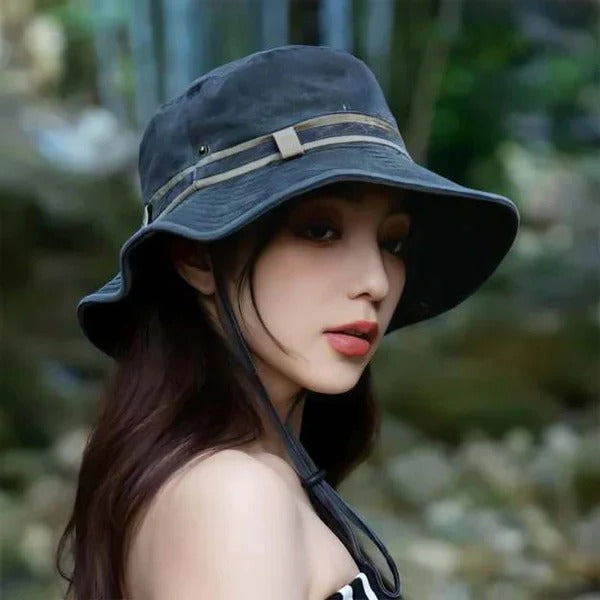 Collapsible unisex travel bucket hat for easy packing, offering sun protection with an adjustable chin strap.